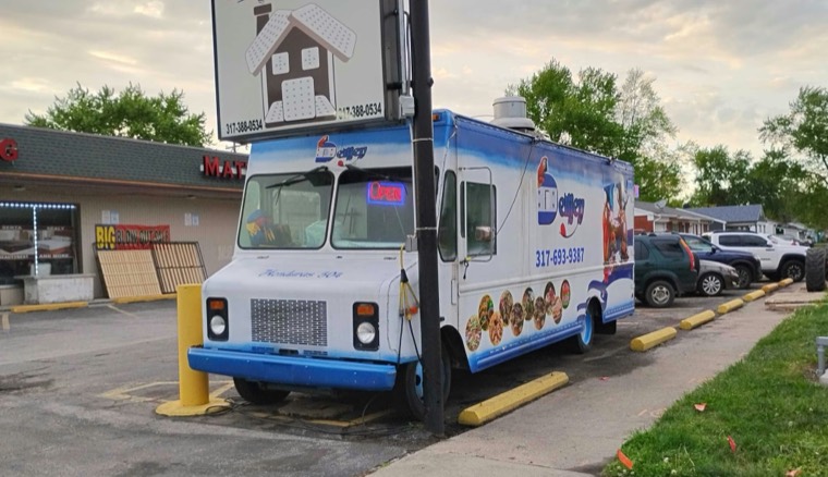 The DeliJey truck in daylight, with the macaw logo and 317-693-9387 painted on the side
